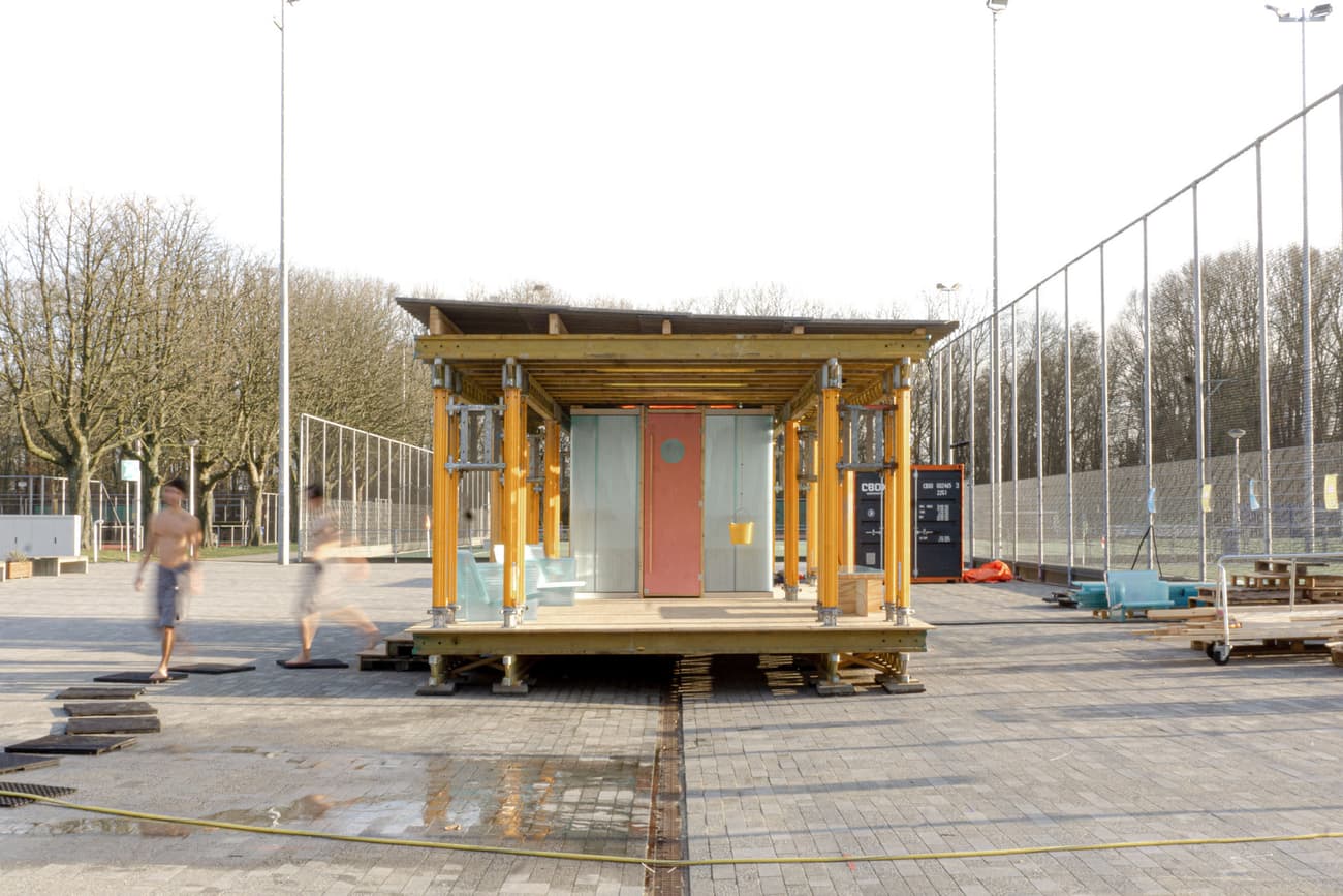 Architectural project - leisure area, wood, timber, temporary structure, urban setting, urban installation, grey, metal, timber frame, outdoor living, sustainable design, yellow, glass, contemporary architecture, innovative design, multi-use space, adaptable design, urban environment, brown, industrial elements, functional design, eco friendly, outdoor structure, Scandinavian style, minimalist style, social space, community hub, public space, small building, modular building, prefabricated structure, portable design, sports facilities, recreation area, compact architecture, kiosk idea, pavilion, modern concept, yellow accents, glass doors, open facade, scaffolding support, wood construction, low carbon footprint, park setting, casual space, meeting point, adaptive reuse, lightweight structure, flexible use