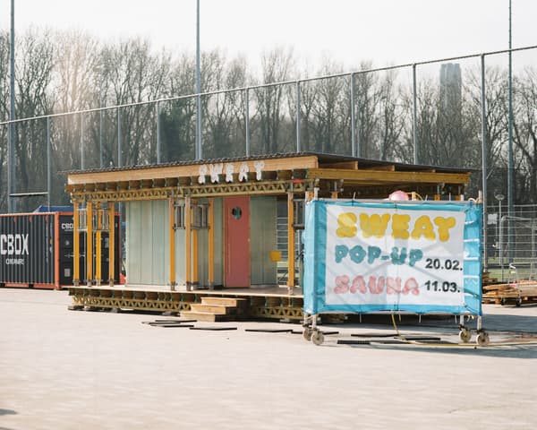 Architectural project - minimalist, relaxation space, timber, metal frame, grey, metal, sustainable design, glass, modular design, transparent walls, urban landscape, timber structure, neutral tones, public area, brown, industrial style, pop-up sauna, portable sauna, outdoor sauna, eco friendly, wood exterior, glass panels, recreational space, modern design, contemporary, temporary architecture, urban sauna, mobile wellness, steel framework, flat roof, boxy design, Scandinavian influence, open structure, airy design, compact space, natural setting, recreational architecture, wellness design, community use, eco structure, urban oasis, outdoor leisure