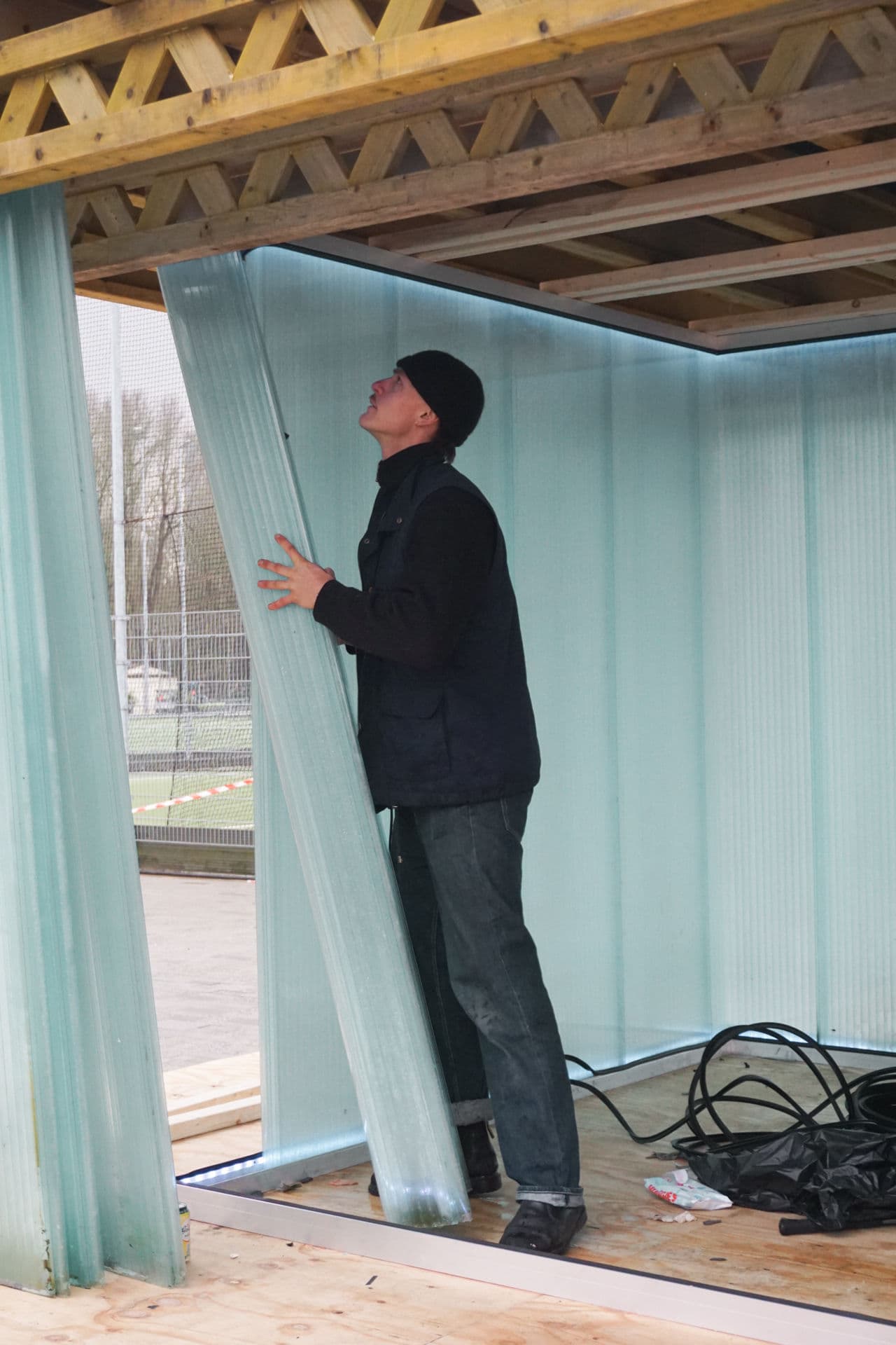 Architectural project - temporary structure, light blue, natural materials, timber, experimental architecture, timber frame, natural light, sustainable design, modular construction, modular design, eco design, innovative design, timber structure, architectural installation, construction phase, building framework, exposed beams, structural timber, polycarbonate sheets, translucent panels, construction site, work in progress, under construction, lattice beams, lightweight design, DIY architecture, contemporary structure, ceiling beams, ventilation, outdoor installation, public installation, modern construction, creative architecture, functional space, material exploration, open frame, carpentry, building assembly, assembly process, translucent material, daylight, user interaction, multi-use space, adaptable design, adjustable space, construction technique, site work, project prototype, polycarbonate, plywood, wood tones, organic construction