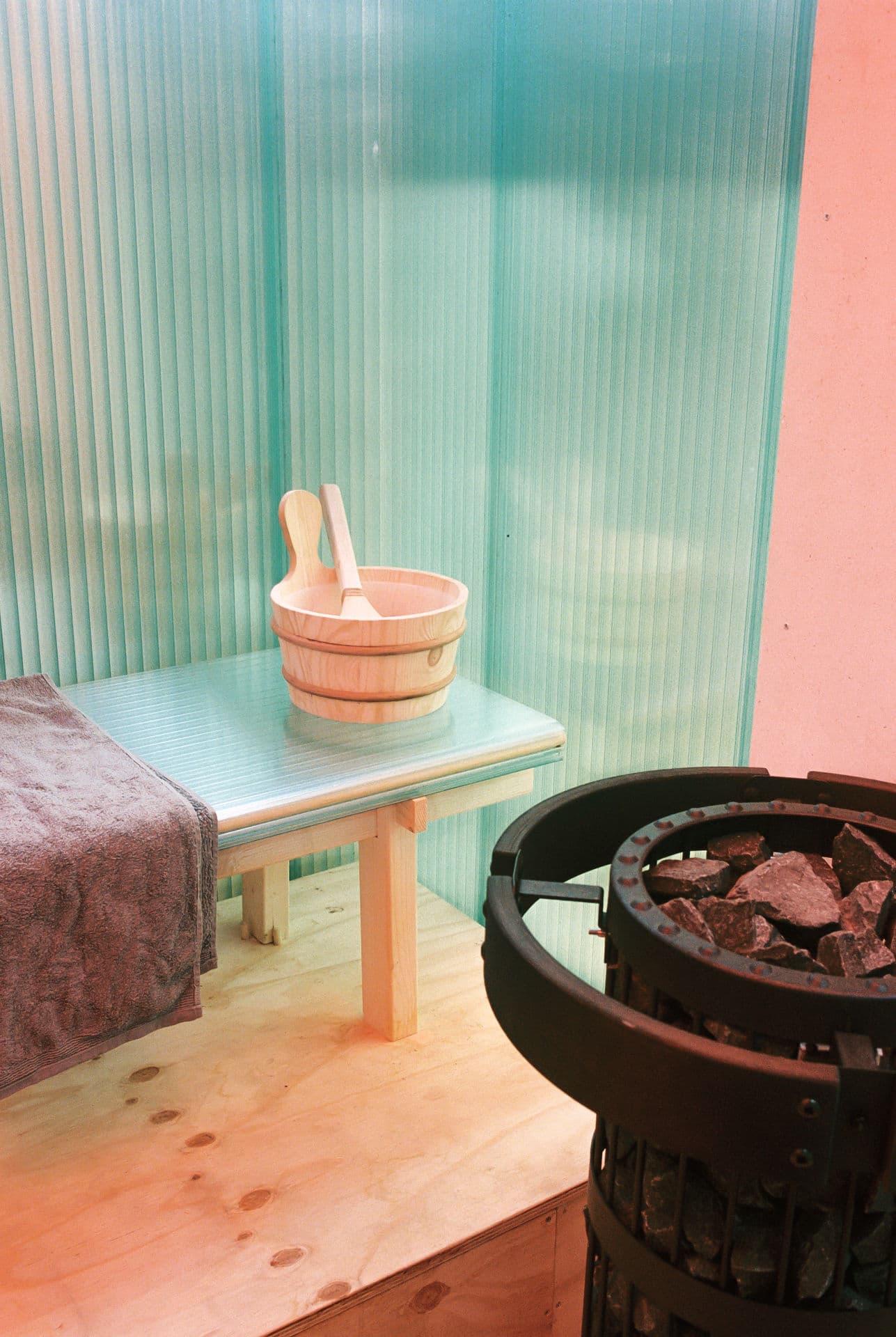 Architectural project - sauna, modern sauna, relaxation space, wellness space, spa design, warm interior, spa retreat, natural materials, wooden bench, eco-friendly design, sustainable materials, pastel tones, wood, relaxation area, inviting atmosphere, warm tones, eco design, green, neutral tones, polycarbonate, beige, light wood, polycarbonate panels, steam room, spa room, calming space, sauna bench, thermal comfort, minimalist design, black, translucent wall, home sauna, private sauna, wooden bucket, sauna stones, heater, Scandinavian vibe, Nordic inspiration, simple space, clean aesthetic, soothing ambiance, cozy space, calming light, pastel green, soft textures, personal spa, tranquil setting, laminated wood, sauna accessories, stones