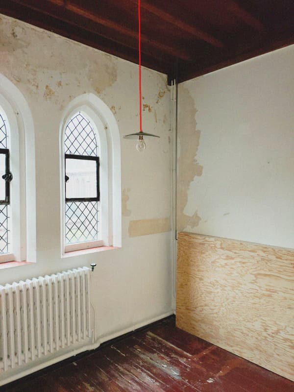 Architectural project - loft style, rustic elegance, rustic interior, vintage vibe, interior window, bohemian touch, historical charm, plywood panel, arched window, renovation project, moody atmosphere, historic renovation, architectural detail, wood, raw materials, metal, natural light, eclectic style, reclaimed materials, natural tones, daylight, rustic charm, industrial touch, wooden floor, white, cozy vibe, textured wall, plaster wall, plaster, minimalist decor, cozy corner, traditional touch, warm lighting, unique design, dark wood, artistic space, creative corner, red