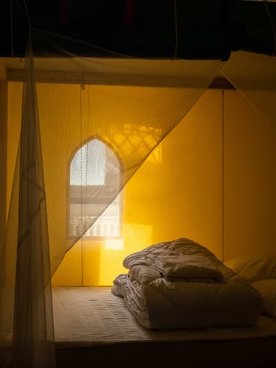 Architectural project - ambient light, soft bedding, muted colors, bedroom, layered textiles, compact room, bohemian touch, intimate nook, relaxing atmosphere, peaceful room, serene vibe, natural materials, natural light, sustainable design, warm tones, eco friendly, personal retreat, intimate setting, cozy retreat, neutral palette, soft textures, tranquil setting, warm ambiance, inviting space, warm atmosphere, relaxing space, warm light, minimalist space, calm atmosphere, simple decor, cozy bedroom