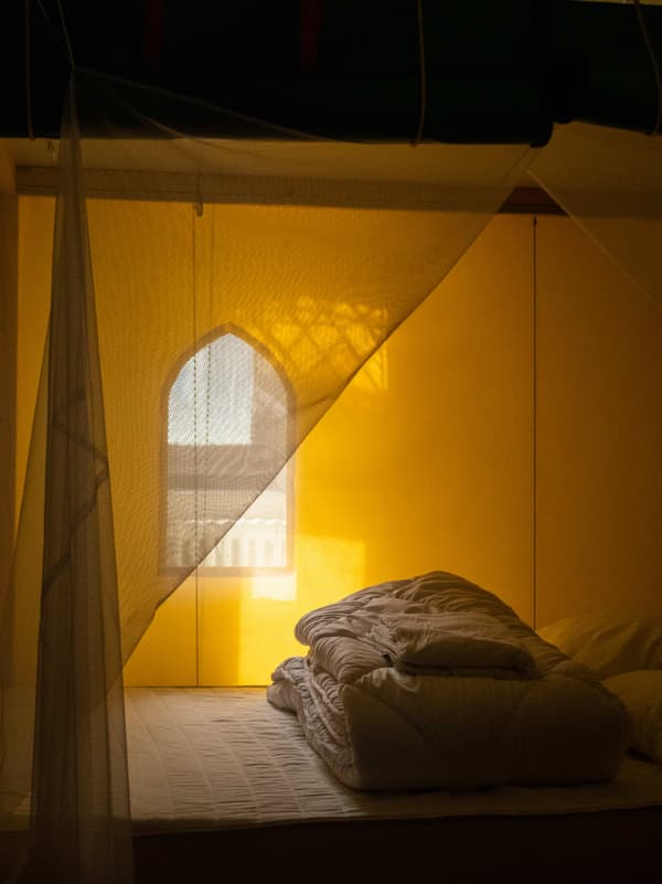 Architectural project - ambient light, soft bedding, muted colors, bedroom, layered textiles, compact room, bohemian touch, intimate nook, relaxing atmosphere, peaceful room, serene vibe, natural materials, natural light, sustainable design, warm tones, eco friendly, personal retreat, intimate setting, cozy retreat, neutral palette, soft textures, tranquil setting, warm ambiance, inviting space, warm atmosphere, relaxing space, warm light, minimalist space, calm atmosphere, simple decor, cozy bedroom