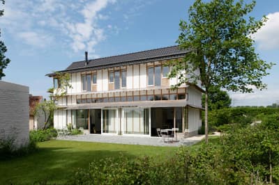 Architectural project - minimal design, relaxation space, sustainable materials, wood, timber, outdoor space, natural light, passive design, glass, contemporary style, green, daylight optimization, eco friendly, Scandinavian style, exterior, outdoor seating, glass doors, light tones, biophilic design, eco home, sustainable home, natural ventilation, modern facade, clean lines, white facade, large windows, simple elegance, white, Nordic design, inviting home, wood frame, energy efficient, airy space, green home, greenery, natural environment, garden view, residential architecture, nature integration, timber siding, family living, wood siding, timber framing, sliding doors, comfortable living, family house, private garden, green lawn, foliage, modern style, soft tones, seamless indoor outdoor, open view, patio furniture, modern living, spacious living, outdoor dining