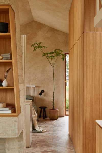 Architectural project - cozy interior, intimate space, calming atmosphere, soft lighting, wood, timber, natural light, sustainable design, contemporary style, neutral tones, beige, light wood, rustic modern, natural textures, light brown, tranquil setting, timber walls, modern rustic, simple elegance, eco friendly home, harmonious design, textured wall, plaster wall, plaster, beige tones, cozy nook, open shelves, airy space, inviting space, earthy tones, quiet retreat, Nordic vibe, Scandinavian design, modern home, functional layout, minimal decor, built-in shelving, serene home, natural home, warm palette, wooden paneling, indoor plant, parquet flooring, bedroom corner, wood finishes, relaxing ambiance, live plant, pottery decor, design simplicity, green plant