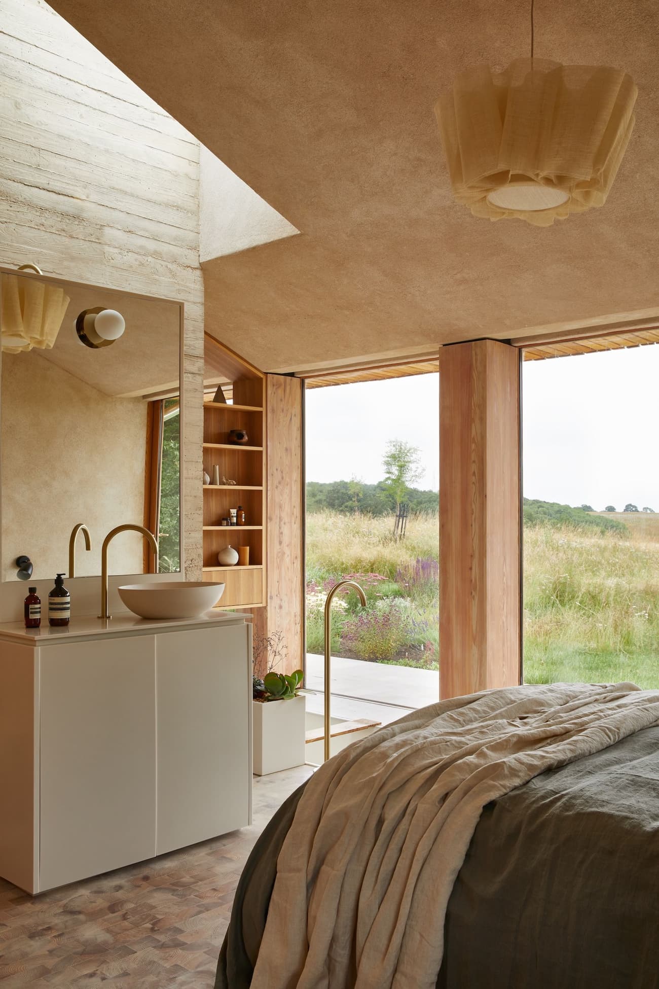 Architectural project - warm interior, calming atmosphere, natural materials, timber, natural light, sustainable design, glass, warm tones, neutral tones, daylight, beige, light wood, natural wood, rustic modern, natural textures, Scandinavian style, serene space, timber elements, modern rustic, eco home, passive house, clean lines, large windows, indoor outdoor, eco friendly home, textured wall, plaster wall, plaster, open layout, open plan, inviting space, earthy tones, Nordic vibe, warm light, countryside living, wooden accents, pendant light, wood paneling, bedroom retreat, cozy bedroom, rustic bedroom, minimalist bedroom, floor to ceiling, glass wall, soft textiles, linen bedding, simple furniture, connection to nature, pastoral views, wooden shelf, built-in shelving, hygge feel, tranquil retreat