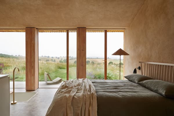 Architectural project - minimal design, timber, timber frame, natural light, sustainable design, glass, warm tones, natural tones, eco design, beige, light wood, eco friendly, simple design, honey wood, rustic modern, Scandinavian style, neutral palette, modern rustic, nature view, Nordic style, countryside home, large window, landscape view, wood frame, minimalist decor, earthy tones, nature-inspired, tranquil vibe, relaxing space, peaceful retreat, rural setting, wooden panels, integrated lighting, wood ceiling, soft light, understated elegance, bedroom retreat, cozy bedroom, rustic bedroom, glass wall, linen, picture window, warm aesthetic, calming vibe, organic textures, linen sheets, sloped ceiling, contemporary country, bedroom sanctuary, green field, expansive view, seamless design