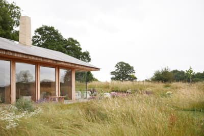 Architectural project - serene vibe, natural materials, wood, timber, timber frame, natural light, sustainable design, glass, warm tones, contemporary architecture, daylight, beige, eco friendly, modern design, flat roof, rural architecture, neutral palette, neutral colors, outdoor seating, warm wood, ecological design, open landscape, eco home, passive house, landscape integration, indoor outdoor, wood cladding, countryside home, beige tones, nature connection, tranquil environment, peaceful retreat, country living, low carbon building, wooden exterior, glass facade, site-specific design, natural surroundings, rural house, modern cabin, expansive windows, seamless view, exterior space, green roof potential, rural retreat, countryside setting, earthy colors, minimalist lines, relaxing home