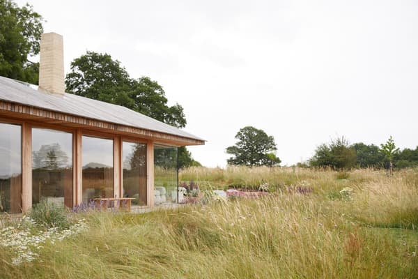 Architectural project - serene vibe, natural materials, wood, timber, timber frame, natural light, sustainable design, glass, warm tones, contemporary architecture, daylight, beige, eco friendly, modern design, flat roof, rural architecture, neutral palette, neutral colors, outdoor seating, warm wood, ecological design, open landscape, eco home, passive house, landscape integration, indoor outdoor, wood cladding, countryside home, beige tones, nature connection, tranquil environment, peaceful retreat, country living, low carbon building, wooden exterior, glass facade, site-specific design, natural surroundings, rural house, modern cabin, expansive windows, seamless view, exterior space, green roof potential, rural retreat, countryside setting, earthy colors, minimalist lines, relaxing home