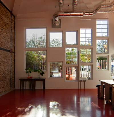 Architectural project - metallic finishes, grid windows, workshop, modern industrial, exposed ductwork, loft style, vibrant atmosphere, red floor, exposed stone, creative studio, studio, metal ducts, glossy floor, upcycled decor, airy interior, urban aesthetic, eclectic design, sustainable space, unique windows, farmhouse touch, light brick, organic elements, natural light, recycled materials, eco design, grey, daylight, industrial vibe, multifunctional space, eco friendly, rustic charm, contemporary design, casual setting, creative space, workspace, large windows, white, window view, open plan, stone wall, rustic wall, cozy corner, bright space, concrete floor, industrial space, indoor plants, mixed materials, versatile space, high ceiling, red, modular elements