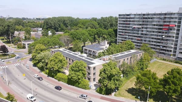 Architectural project - urban greenery, multi-story building, residential complex, pedestrian friendly, grass, solar panels, urban habitat, shared garden, communal living, bicycle friendly, city development, neighborhood, eco-friendly design, city living, cityscape, outdoor space, glass, community space, urban landscape, contemporary style, sustainable architecture, urban planning, concrete, low carbon design, eco building, modern facade, energy efficient, greenery, environmental architecture, nature integration, green design, passive solar, urban nature, residential area, green roof, aerial view, trees, energy conservation, street view
