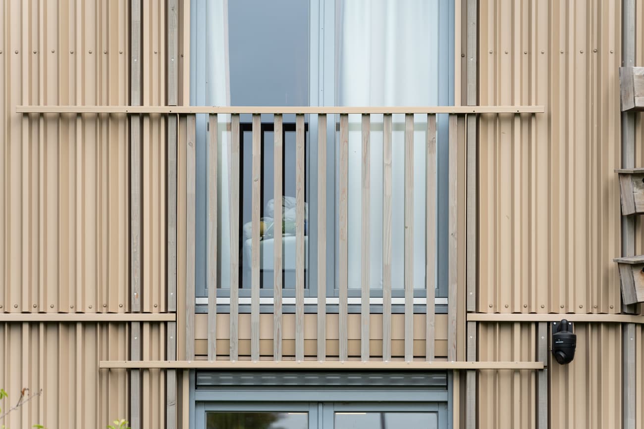 Architectural project - facade, beige facade, rhythmic pattern, linear design, modern apartment, urban dwelling, vertical lines, curtain, minimal design, architectural detail, sustainable design, warm tones, eco design, contemporary style, neutral tones, wood facade, timber facade, exterior design, geometric pattern, light wood, daylight optimization, exterior, modern aesthetics, natural material, low carbon, natural ventilation, modern facade, clean lines, timber cladding, wood cladding, energy efficient, warm beige, wood slats, vertical cladding, vertical slats, facade texture, architectural rhythm, window detail, sustainable living, residential facade