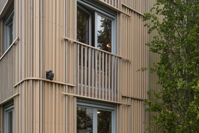 Architectural project - modern building, linear design, facade depth, urban dwelling, vertical lines, green facade, ribbed cladding, exterior architecture, rhythmic facade, natural materials, architectural detail, wood, timber, city living, warm tones, eco design, green building, innovative design, neutral tones, beige, timber facade, exterior design, minimalist facade, light wood, facade detail, light brown, biophilic design, passive house, natural ventilation, energy efficient, greenery, wooden facade, residential building, sustainable facade, contemporary facade, urban nature, vertical cladding, facade texture, architectural rhythm, apartment building, eco facade