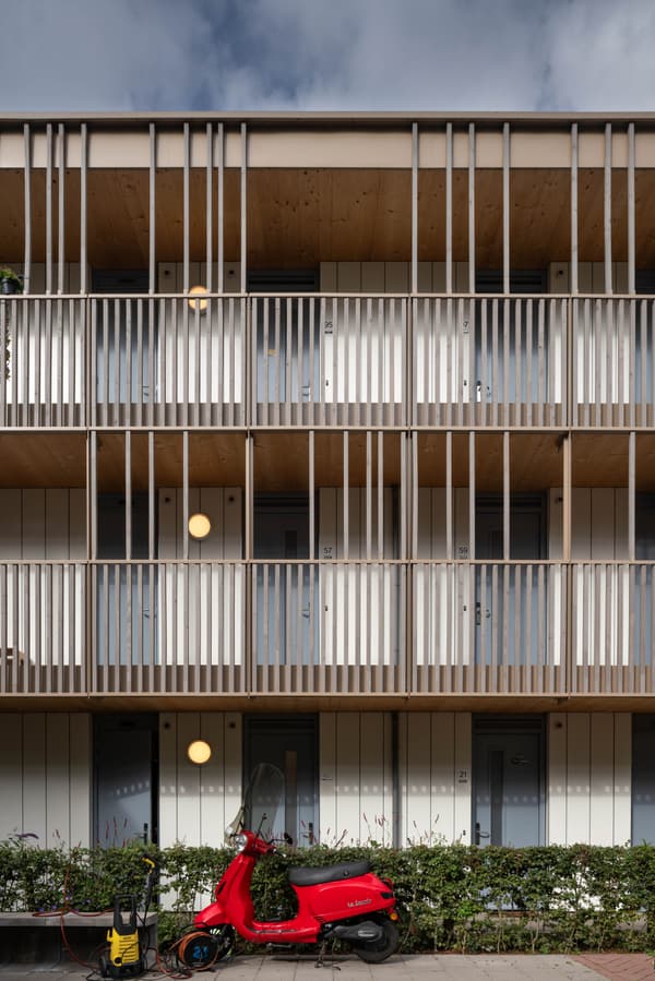 Architectural project - beige facade, urban dwelling, exterior lighting, community living, multi-family home, rhythmic facade, wood, timber, metal, outdoor space, sustainable design, natural tones, eco design, grey, beige, timber facade, minimalist facade, functional design, facade detail, neutral palette, minimalist design, urban design, geometric design, passive house, modern facade, clean lines, timber cladding, white, residential architecture, wood slats, wooden facade, compact living, modern style, urban architecture, vertical slats, modern exterior, architectural rhythm, apartment building, residential facade, urban living, contemporary building, open balconies