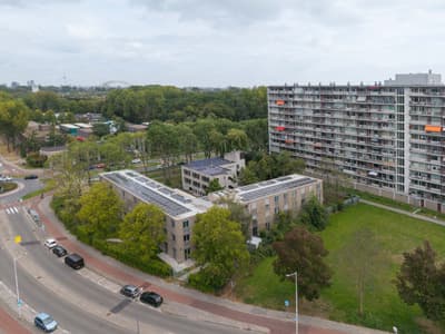 Architectural project - sustainable housing, residential complex, smart design, city life, solar panels, community living, multi-family housing, energy conscious, sustainable materials, grey tones, cityscape, outdoor space, sustainable design, contemporary architecture, sustainable architecture, urban development, urban environment, urban planning, exterior design, neutral colors, public space, low carbon, modern facade, clean lines, energy efficient, landscape design, eco-friendly building, passive solar, residential area, green space, natural surroundings, renewable energy, apartment building, modern urban, urban living, high-rise building