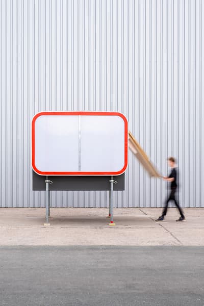 Architectural project - smart design, red accent, contemporary installation, portable space, metal facade, aluminum cladding, bright accent, compact building, transportable architecture, prefabricated design, minimalist color scheme, light grey, urban furniture, moving art, functionality, practicality, grey tones, temporary structure, industrial design, functional art, sustainable design, lightweight construction, neutral tones, architectural installation, outdoor installation, modern aesthetic, temporary building, eco friendly, minimalist style, flexible use, urban design, mobile unit, modular structure, pop-up structure, adaptable space, street furniture, industrial chic, corrugated metal, clean lines, sleek design, innovative architecture, low impact design, efficient space