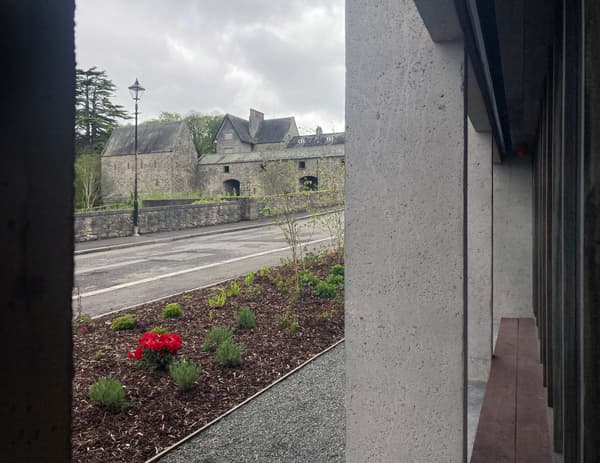 Architectural project - natural stone, scenic backdrop, concrete texture, concrete walls, landscaped garden, cultural heritage, heritage conservation, architectural heritage, historic vibe, heritage site, medieval style, stone building, pathway design, courtyard garden, historical site, castle-like, cityscape, outdoor space, sustainable design, grey, rustic charm, serene atmosphere, public space, outdoor seating, adaptive reuse, urban design, eco-friendly materials, modern facade, window view, traditional architecture, landscape design, exterior view, grey stone, timeless design, architectural contrast, muted tones, street view