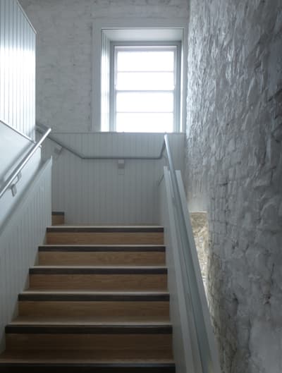 Architectural project - textured surfaces, light grey, brick wall, cozy ambiance, transitional space, homely feel, Scandinavian touch, timeless style, wooden steps, classic design, wood stairs, multi-level, stair railing, residential stair, serene vibe, architectural detail, eco-friendly design, natural light, grey, neutral tones, daylight, light wood, rustic charm, calming space, clean aesthetic, modern rustic, sustainable home, white walls, elegant design, white, textured wall, energy efficient, stone wall, traditional style, bright space, home design, airy atmosphere, interior design, simple lines, smooth finish, staircase, timber steps, stairwell