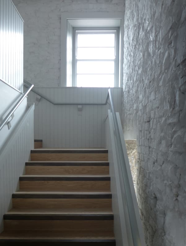 Architectural project - textured surfaces, light grey, brick wall, cozy ambiance, transitional space, homely feel, Scandinavian touch, timeless style, wooden steps, classic design, wood stairs, multi-level, stair railing, residential stair, serene vibe, architectural detail, eco-friendly design, natural light, grey, neutral tones, daylight, light wood, rustic charm, calming space, clean aesthetic, modern rustic, sustainable home, white walls, elegant design, white, textured wall, energy efficient, stone wall, traditional style, bright space, home design, airy atmosphere, interior design, simple lines, smooth finish, staircase, timber steps, stairwell