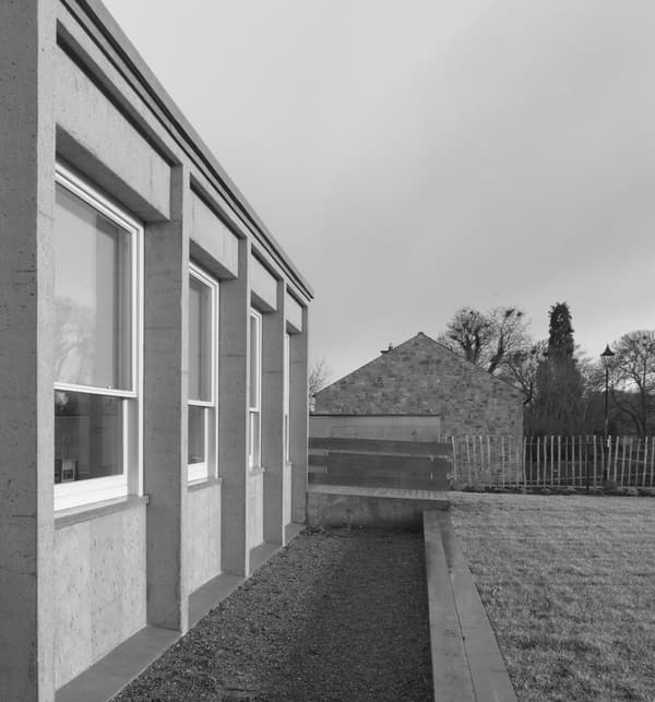 Architectural project - rural landscape, modern farmhouse, symmetrical design, natural materials, eco-friendly design, outdoor space, natural light, contemporary architecture, sustainable architecture, grey, neutral tones, daylight, concrete, sleek lines, minimalist style, minimalist design, outdoor seating, natural landscape, eco build, low carbon, thermal mass, large windows, architectural details, energy efficient, rough texture, countryside view, earthy tones, rural setting, garden view, nature integration, textured facade, passive solar, simple lines, modern exterior, insulation, suburban home, window frame, concrete wall, understated elegance, rural house, black and white