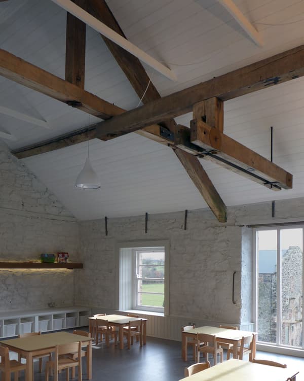 Architectural project - light grey, sustainable space, stone walls, home dining, cozy dining, vintage vibe, Scandinavian touch, rustic dining, minimalist furniture, barn conversion, simple chairs, open beams, relaxed dining, warm interior, natural materials, wood, timber, natural light, warm tones, eco design, neutral tones, exposed beams, wooden ceiling, beige, light wood, wooden beams, farmhouse style, timber beams, rustic charm, white, cozy vibe, Nordic style, large window, stone, plaster, timber ceiling, countryside view, family space, dining area, inviting space, casual dining, traditional design, heritage building, textured walls, rural charm, nordic influence, open view