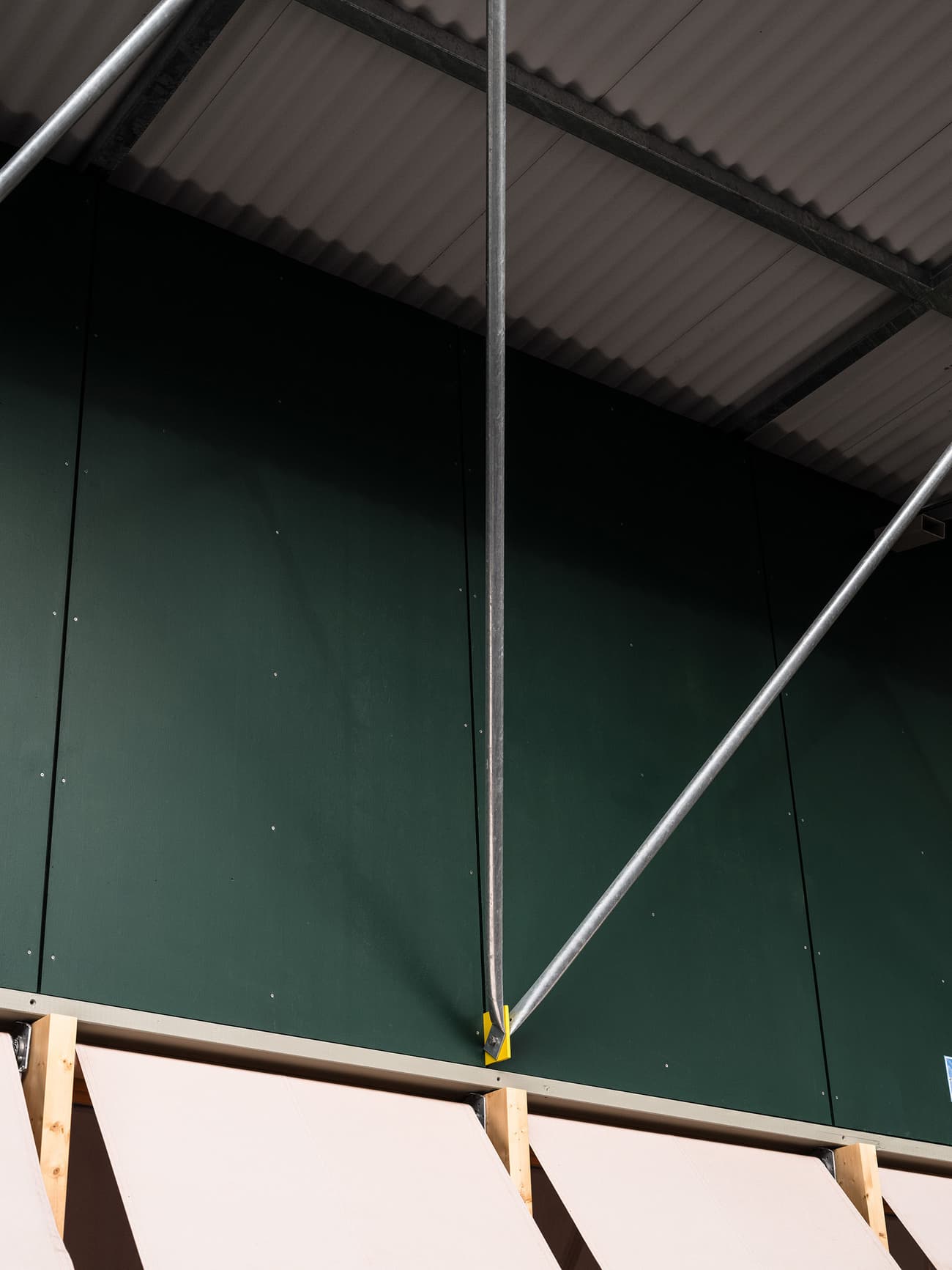 Architectural project - open ceiling, metal structure, construction elements, industrial interior, warehouse vibe, modern ceiling, dark green, ribbed ceiling, diagonal bracing, functional architecture, commercial building, utility elements, light support, structural art, steel tubing, modern warehouse, industrial look, engineering focus, exposed metal, industrial green, ribbed metal, minimalist colors, architectural detail, industrial design, raw materials, steel, metal, eco design, corrugated roof, industrial aesthetic, contemporary style, grey, exposed beams, structural design, functional design, steel framework, simple materials, industrial chic, sustainable building, structural integrity, minimalist space, open space, high ceiling, architectural geometry, green wall, exposed ceiling