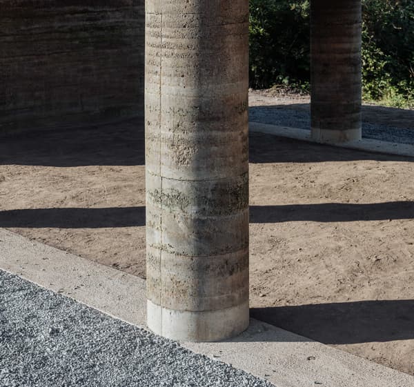 Architectural project - garden architecture, rustic courtyard, earth wall, earthy architecture, earth material, natural terrain, natural architecture, landscape elements, minimal design, raw materials, outdoor space, passive design, sustainable design, eco design, sustainable construction, simple structure, eco friendly, rustic vibe, natural textures, minimalist style, neutral palette, passive cooling, rammed earth, thermal mass, textured surface, rustic style, earthy tones, environmental design, landscape design, craftmanship, tactile surface, natural construction, gravel path, outdoor design, courtyard, brown tones
