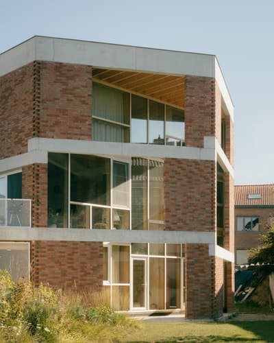 Architectural project - modern building, textured surfaces, glazed facade, urban regeneration, angular architecture, garden integration, glass elements, townhouse design, visual contrast, architectural grid, city house, sustainable materials, cityscape, outdoor space, natural light, glass, warm tones, daylight, beige, concrete, exterior design, geometric design, green architecture, modern facade, large windows, energy efficient, earthy tones, brick, brick facade, exterior view, residential architecture, passive solar, modern living, urban context, urban garden, eco conscious design, warm materials, expansive windows, warm palette, urban home, architectural lines, residential facade, concrete accents, brick building, urban living, red