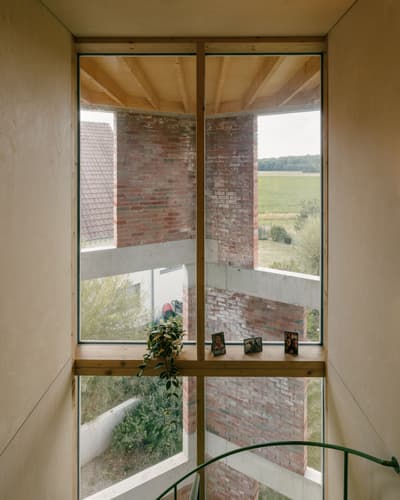 Architectural project - green accents, blending with nature, exposed beam, interior view, wood, timber, natural light, rustic touch, glass, warm tones, eco design, sustainable architecture, neutral tones, functional space, daylight, wooden ceiling, light wood, natural wood, rustic modern, serene atmosphere, neutral palette, minimalist design, modern rustic, nature view, light filled, indoor outdoor, cozy vibe, large window, plaster, timber ceiling, countryside view, rural view, brick, outdoor connection, cozy corner, brick facade, exterior view, bright interior, simple decor, modern rural, glass facade, warm palette, picture window, indoor plants, minimalist interior