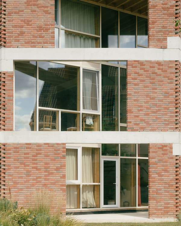 Architectural project - airy interior, landscaping, multi-level, timber, outdoor space, natural light, sustainable design, glass, warm tones, neutral tones, daylight, minimalist facade, functional design, serene atmosphere, minimalist architecture, contemporary design, geometric design, modern facade, clean lines, large windows, eco friendly home, energy efficient, wood accents, inviting space, brick facade, red brick, residential home, private residence, bright interior, family home, passive solar, cozy home, glass facade, architectural contrast, urban home, brick building, urban living, modern residential