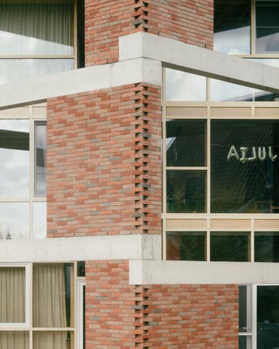 Architectural project - urban dwelling, exposed brick, low carbon materials, structural expression, concrete frame, rhythmic facade, architectural detail, natural light, glass, eco design, urban landscape, sustainable architecture, grey, neutral tones, daylight, industrial vibe, city building, concrete, modern aesthetic, industrial touch, geometric design, modern facade, large windows, white, glass window, robust design, brick, brick facade, red brick, minimalist exterior, residential building, urban architecture, modern exterior, architectural rhythm, window detail, mixed materials, texture contrast, urban style, brick texture, urban vibe, red, contemporary building