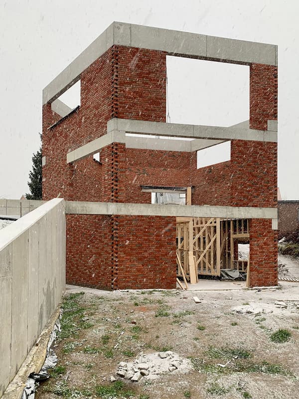 Architectural project - raw textures, rugged landscape, brickwork, exposed brick, concrete frame, architectural concept, timber framework, eco design, sustainable construction, exposed structure, neutral tones, construction site, modern construction, plywood, outdoor construction, urban environment, construction process, brown, concrete, unfinished structure, industrial style, timber supports, natural setting, wooden beams, minimalist design, low carbon construction, prefab elements, passive house, earthy tones, brick, brick facade, red brick, modern style, building project, geometric form, red, structural grid