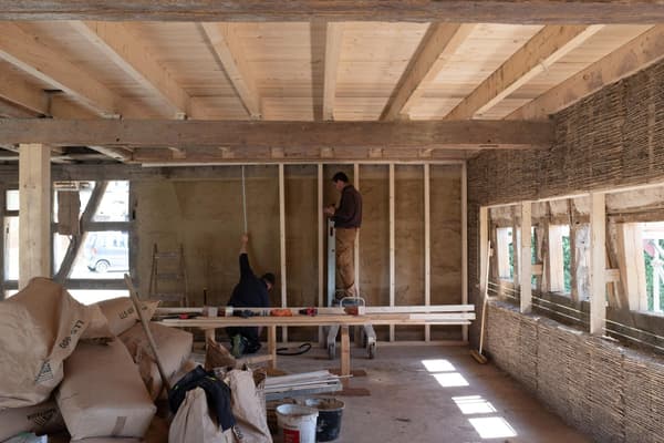 Architectural project - DIY project, straw, rustic interior, earth wall, renovation project, unfinished space, straw wall, plasterwork, interior construction, traditional build, craftwork, window lighting, construction tools, residential project, sustainable insulation, artisan build, earth, indoor space, natural materials, wood, timber, natural light, reclaimed materials, warm tones, timber structure, construction site, work in progress, exposed beams, ceiling beams, daylight, building site, beige, brown, wooden beams, rustic vibe, neutral palette, eco-friendly materials, sustainable building, rammed earth, thermal mass, earth tones, eco home, wood framing, plaster, inviting space, handcrafted, cozy atmosphere, family home, craftsmanship, passive solar, home interior, straw bale, home renovation