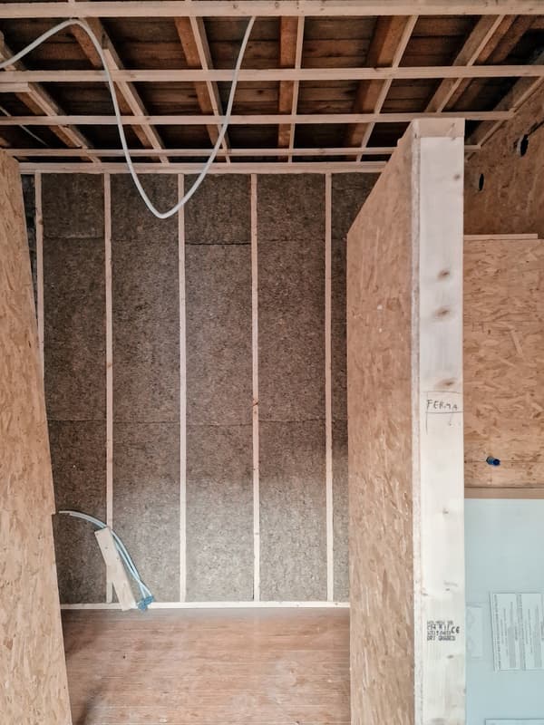 Architectural project - workshop vibe, raw aesthetic, industrial look, OSB panels, OSB, renovation project, exposed framing, ceiling structure, in-progress, insulation visible, space frame, unfinished walls, rustic construction, home build, natural materials, wood, timber, timber frame, warm tones, natural tones, modular design, eco design, simple structure, construction phase, under construction, functional space, plywood, building site, beige, brown, light wood, engineered wood, compact space, eco-friendly construction, construction details, building process, minimalist structure, wood structure, unfinished interior, sustainable building, plywood wall, structural wood, raw texture, wooden elements, wood ceiling, structural elements, practical design